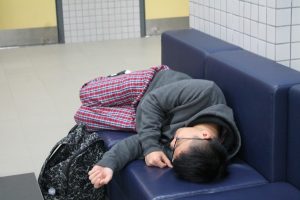 Kelvin falls asleep in his comfortable pajamas on the uncomfortable school sofas.