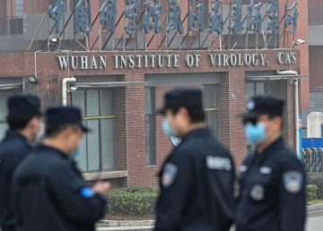 Security guards outside the Wuhan Institute of Virology in Wuhan, China, on Feb. 3. (Thomas Peter/Reuters)