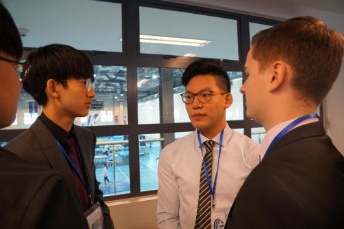 Junior Gabriel Kim chats with fellow delegates from other schools in Crisis Council during the lobbying session. 