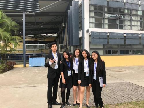 A group of AISG's UNISMUN delegates stand together to take a group photo. 